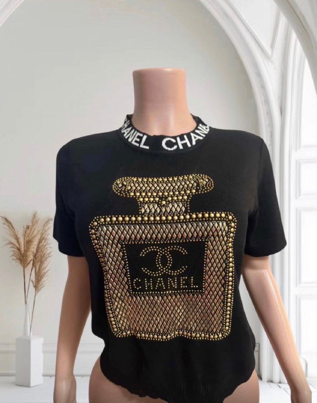 Gold perfume black top
